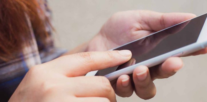 close-up-woman-hand-using-smart-mobile-phone-with-blank-display-concrete-wall-background-vintage-effect-style-pictures-panoramic-banner-2